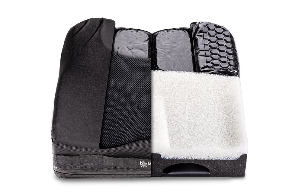 Przekrój poduszki z czarnym pokrowcem ukazujący warstwy pianki, wkłady żelowe i siateczkową osłonę.