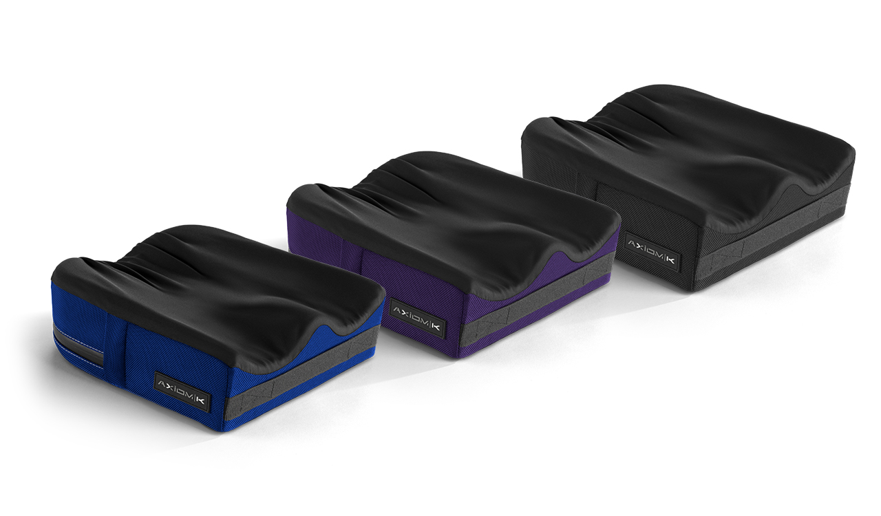 Trzy profilowane poduszki siedziska z czarną górą i kolorowymi bokami (niebieski, fioletowy, czarny) ustawione w rzędzie.